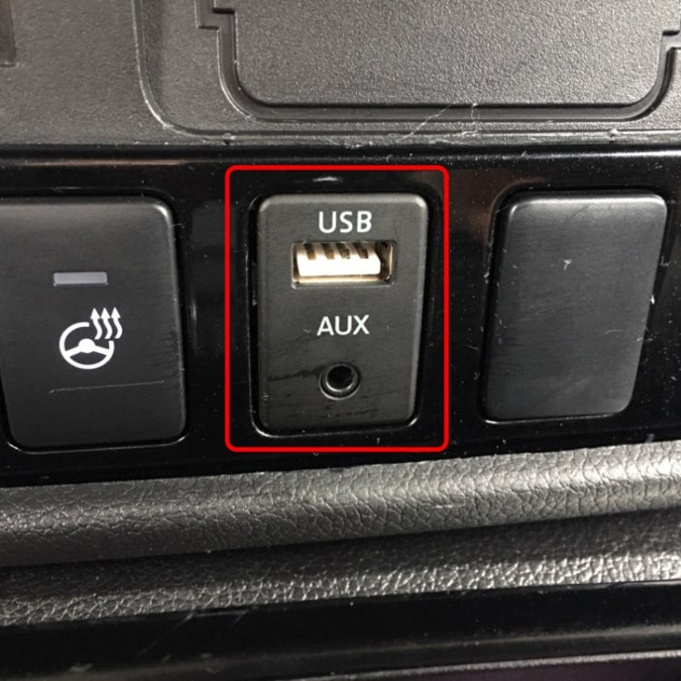 Car dashboard AUX and USB ports panel, with USB slot above AUX jack