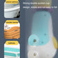 Baby penguin bath water toy base with double suction cups, shown with water splash