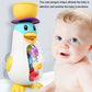 Baby penguin bath water toy with yellow top beside a smiling baby
