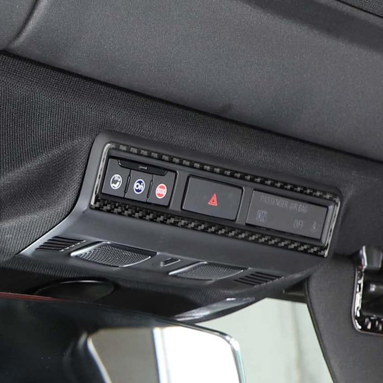 Close-up of carbon-fiber warning light switch frame sticker on dashboard panel