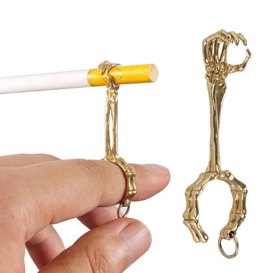 Gold-plated skull hand cigarette clip ring with open hoop and finger grip