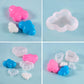 Small cloud-shaped silicone mold pieces in pink, blue, and white