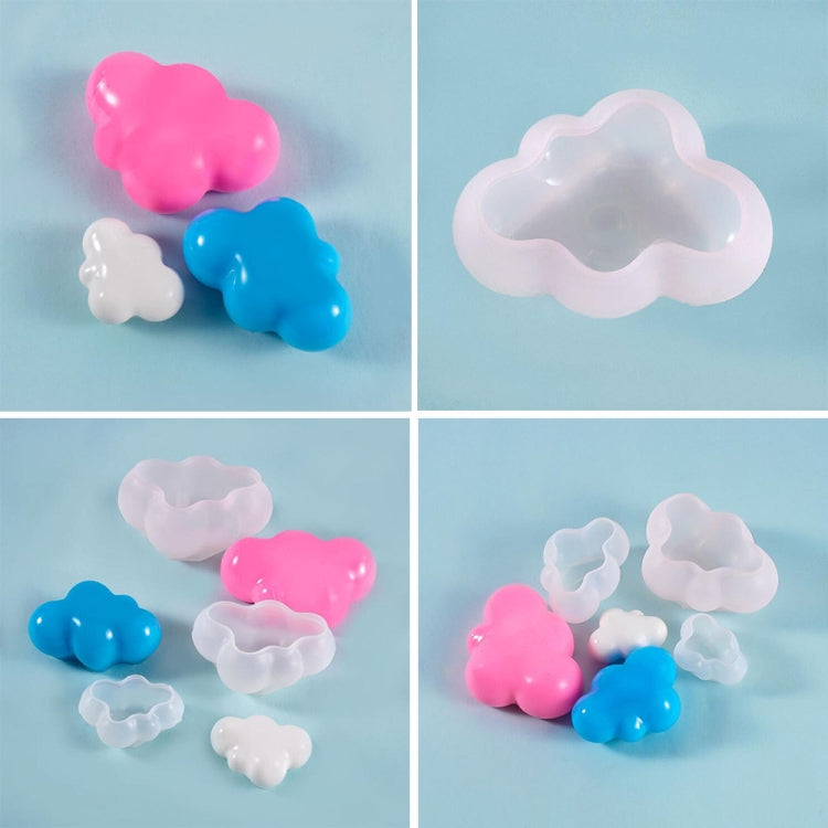 Small cloud-shaped silicone mold pieces in pink, blue, and white