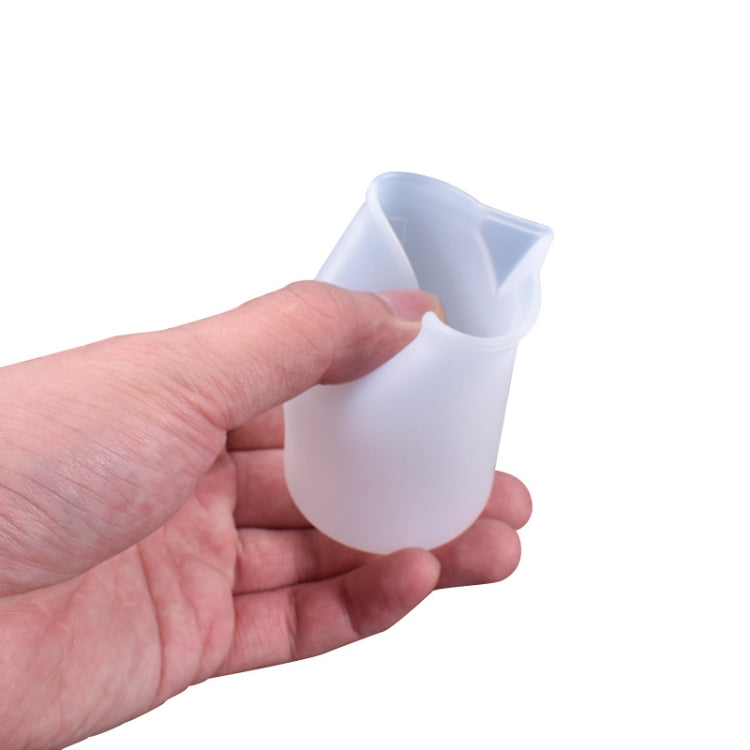 Small translucent 100ml silicone measuring cup with flexible rim and graduated scale markings
