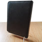 Black leather-look card panel with clear acrylic picture frame stand supports