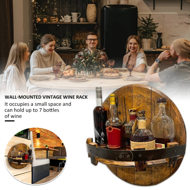 Round wooden wall-mounted wine rack with black strap holding multiple wine bottles for display.