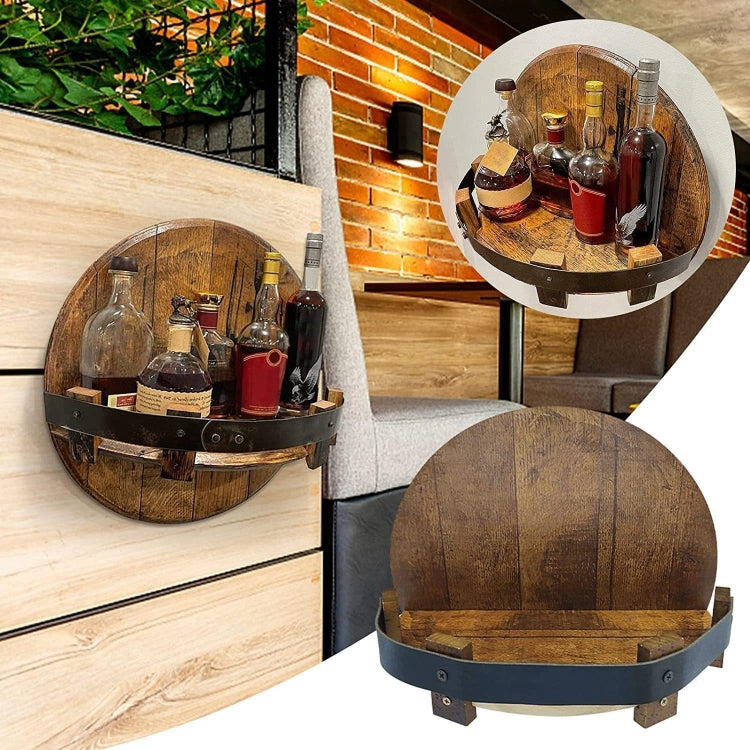 Wooden barrel-style wall-mounted wine rack with black strap, holding wine bottles (two units).
