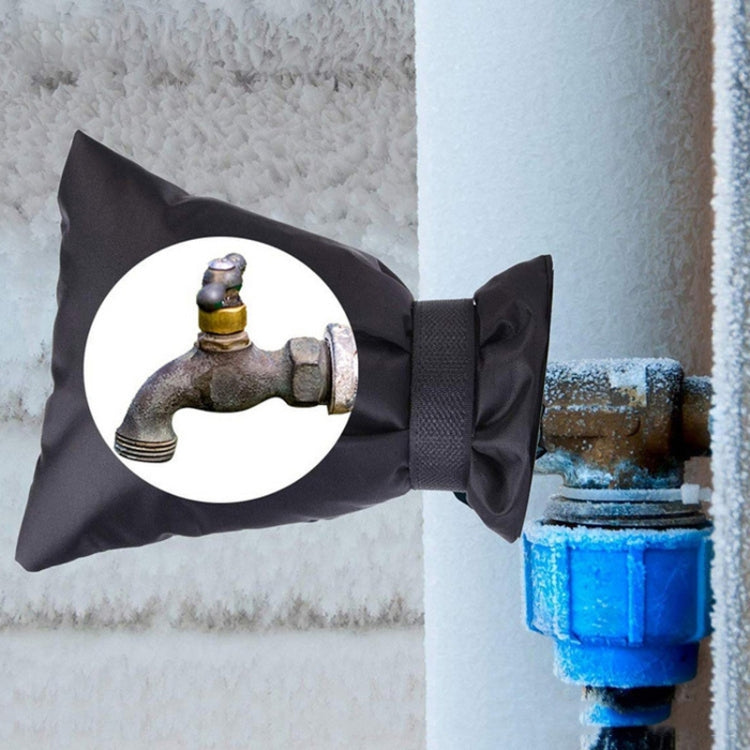 Outdoor faucet frost protection cover in black fabric, secured with hook-and-loop strap