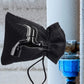 Outdoor faucet frost protection cover in black fabric with rope tie closure