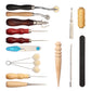 Leather craft tool set close-up with awls, scrapers, thread spool, and edge tools