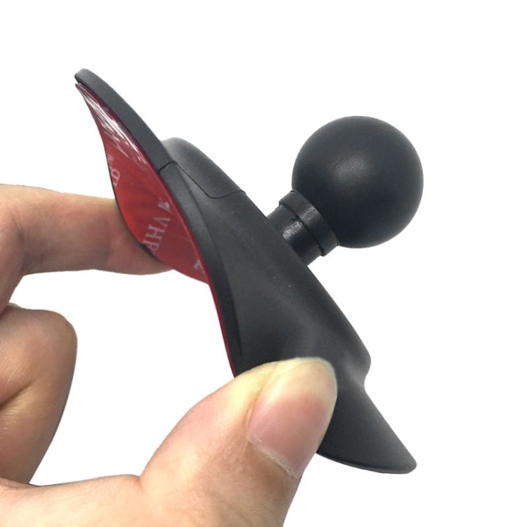 Black dashboard phone holder suction pad with ball mount, held by hand