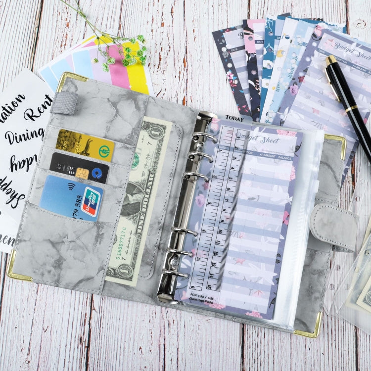 A6 binder budget book open with marbled PU cover, card slots, ring binder pages and pocket