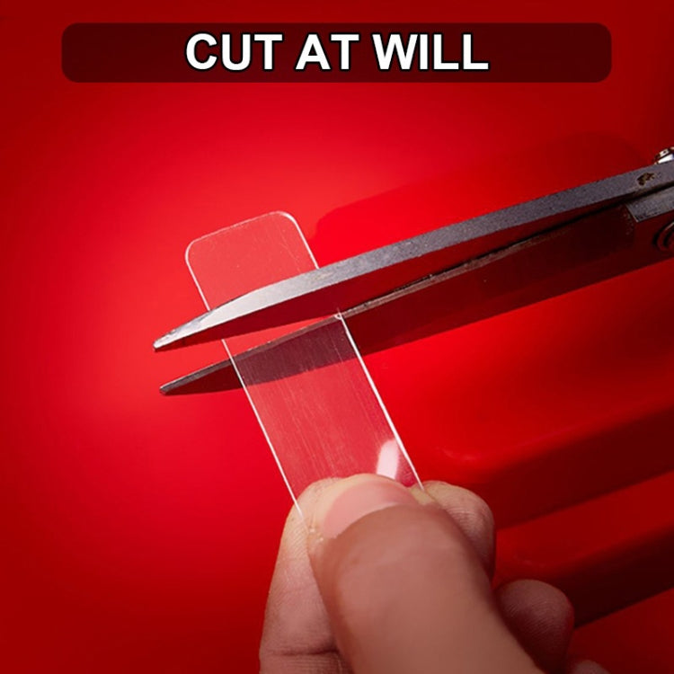 Clear double-sided tape sticker sheet being cut with scissors