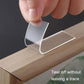 Clear double-sided tape sticker being applied to wood surface