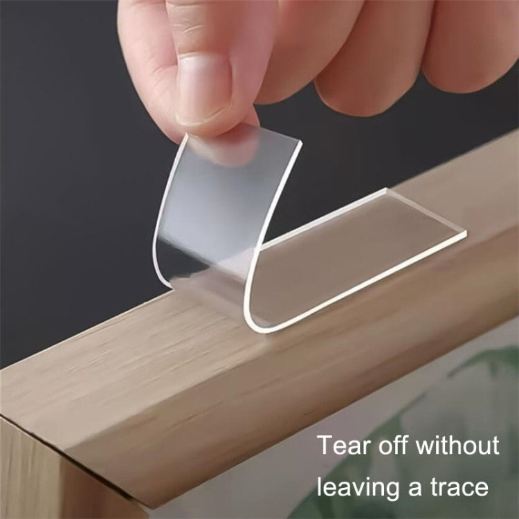 Clear double-sided tape sticker being applied to wood surface