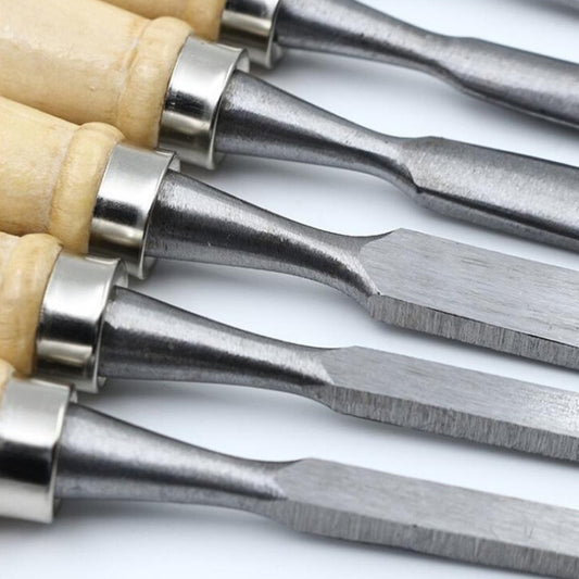 Close-up of steel chisel blades with light wood handles