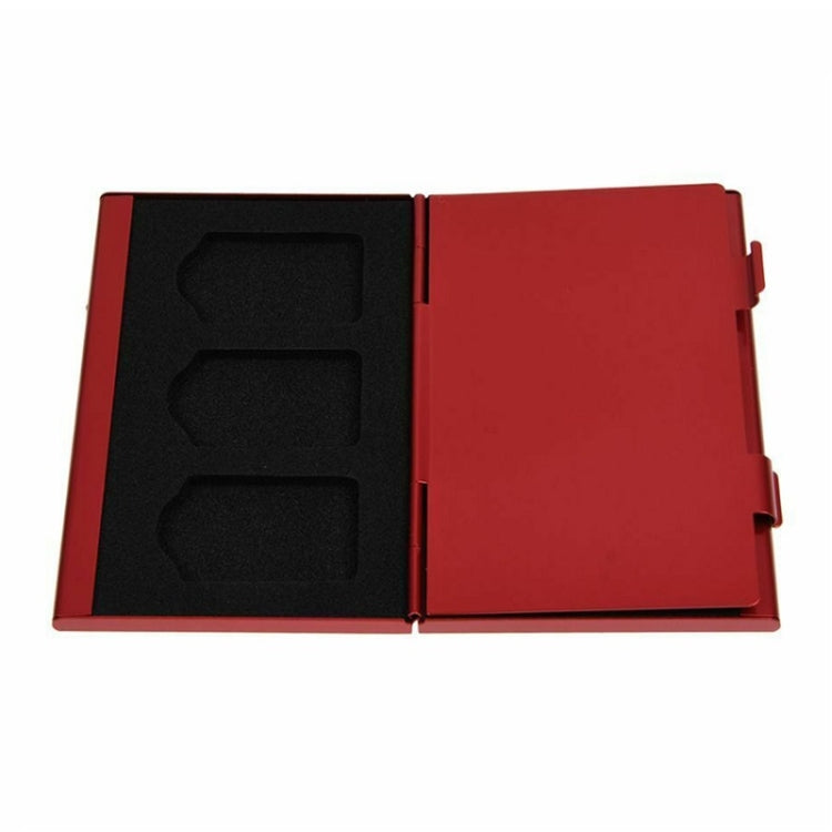 Red aluminum game card storage case open, showing black molded card slots