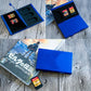 Blue aluminum game card storage case with black insert holding multiple game cards