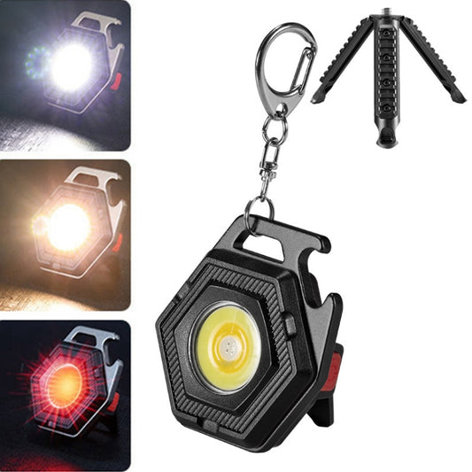 Mini keychain LED flashlight with fold-out tripod legs, black body and yellow LED