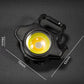 Compact black keychain flashlight with yellow LED lens and top carry handle.
