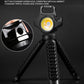Black mini keychain flashlight with yellow LED on a fold-out tripod stand.