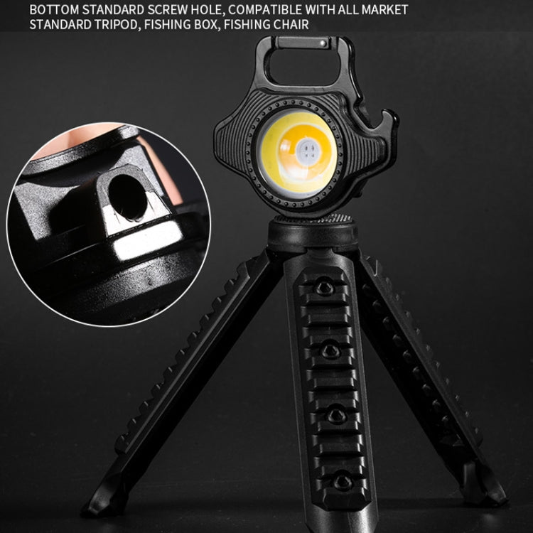 Black mini keychain flashlight with yellow LED on a fold-out tripod stand.