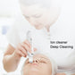 White handheld ion cleaner used on face with scraper tip above the nose