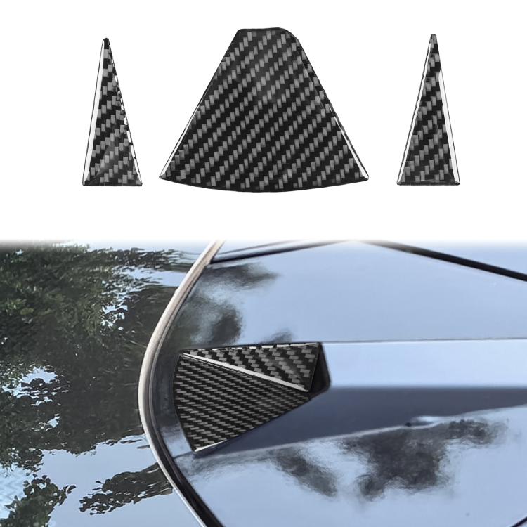 Carbon-fiber look triangular sticker applied to rear camera corner trim