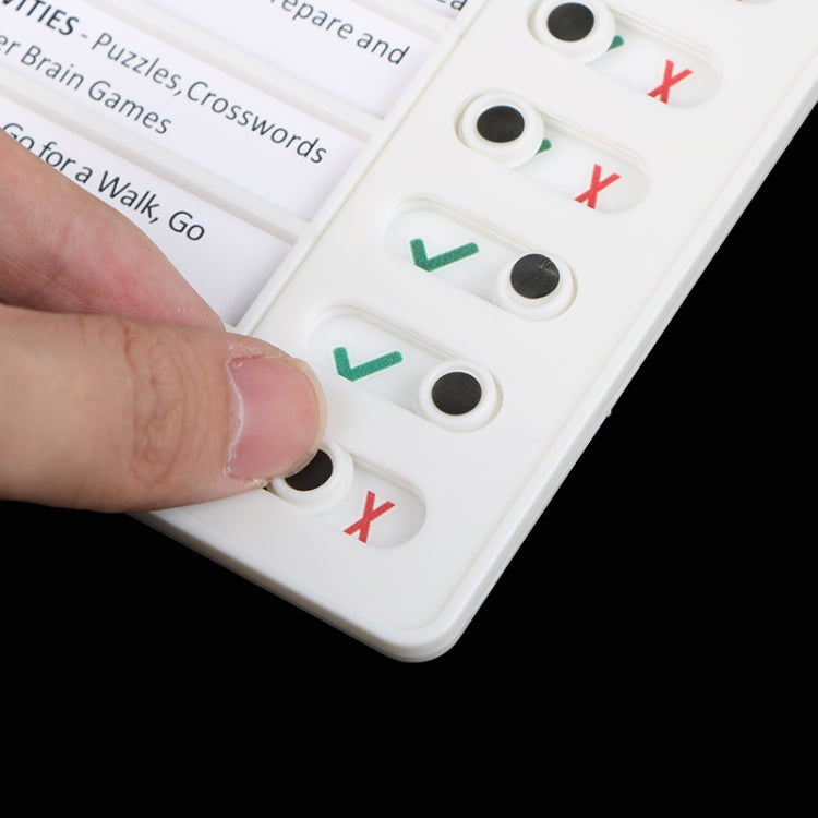 Close-up of white checklist memo board buttons showing green checks and red X marks