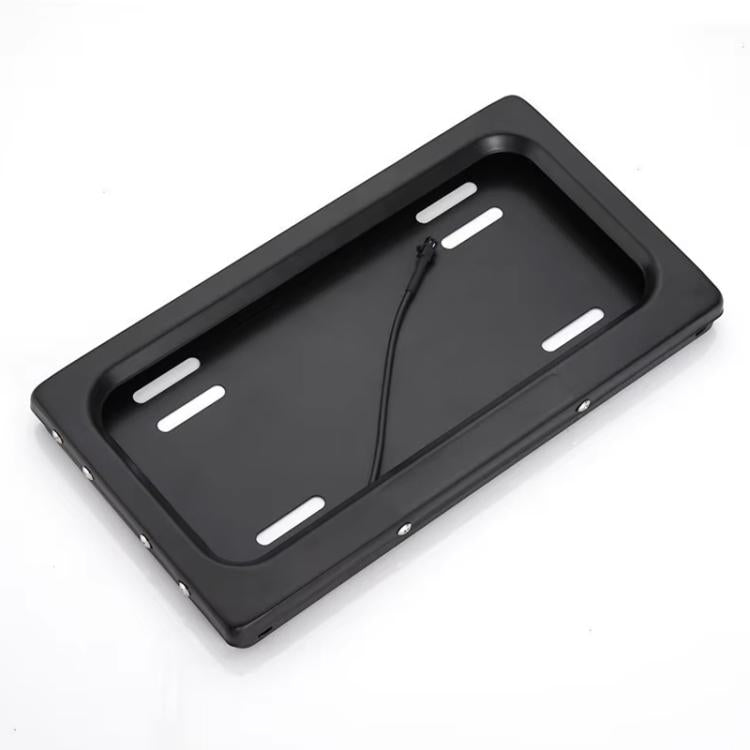 Black license plate bracket shell with four mounting slots and curved top