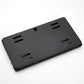 Black license plate bracket with perforated mounting slots and rear mounting tabs