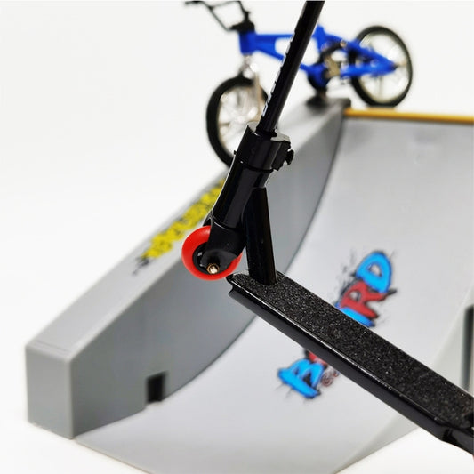Close-up of a finger skateboard deck on a grey mini ramp with bike above