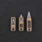 Three brass mini push-pull knife pendants with hanging loops and blades extended