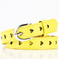 Yellow women’s belt with heart cutouts and silver buckle
