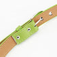 Green leather belt end with heart cutouts, metal eyelets, and stitched keeper tab