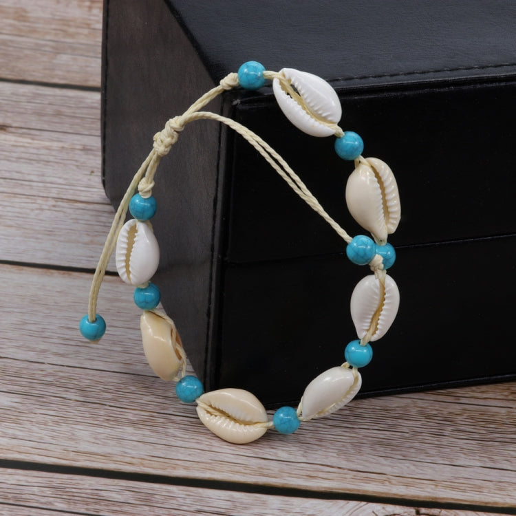 Adjustable braided rope bracelet with white cowrie shells and turquoise blue beads