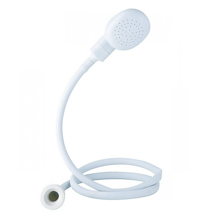 White handheld shower head on short hose, round face with multiple spray holes