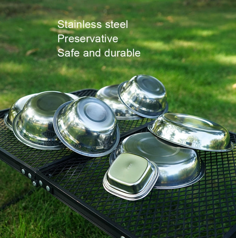 Stainless steel dinner plates on outdoor grilling mat