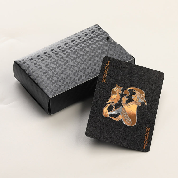 Black playing cards with gold JOKER and pirate-style artwork, in gray patterned box