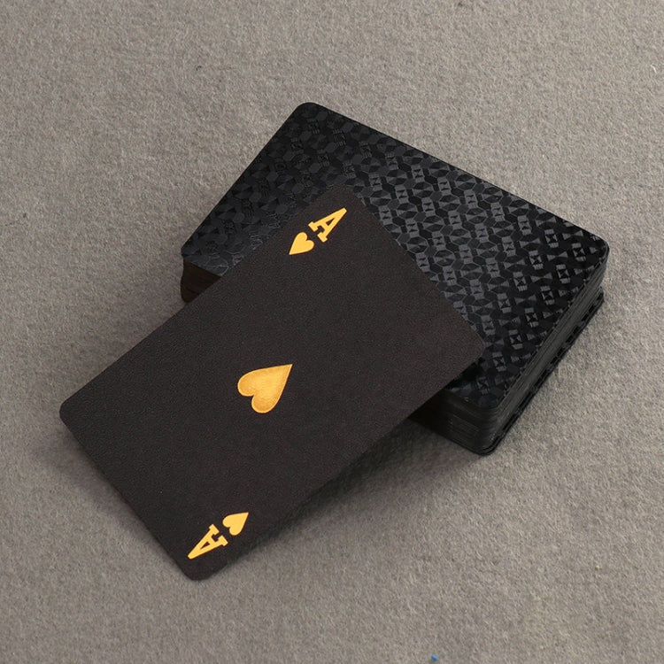 Black playing card laid over a stack, showing a gold Ace and suit icon