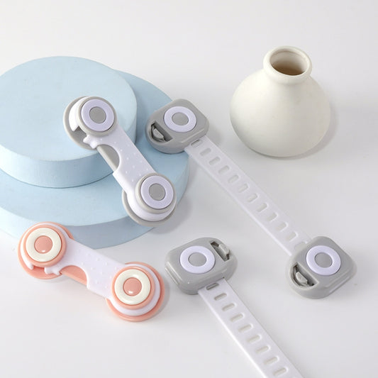 Child drawer safety locks, white and gray straps with orange and light purple circular stops