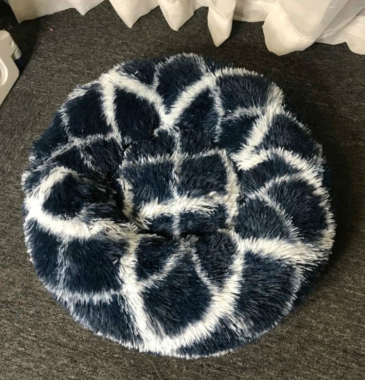 Round pet bed in dark blue with long shag fur and bold white geometric pattern
