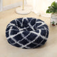 Dark blue round shag pet bed with long fur and white abstract pattern