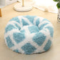 Light blue round shag pet bed with long fur and white abstract pattern