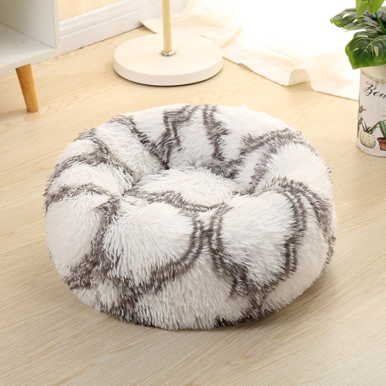 Gray round plush pet bed with long shag fur and white abstract swirl pattern
