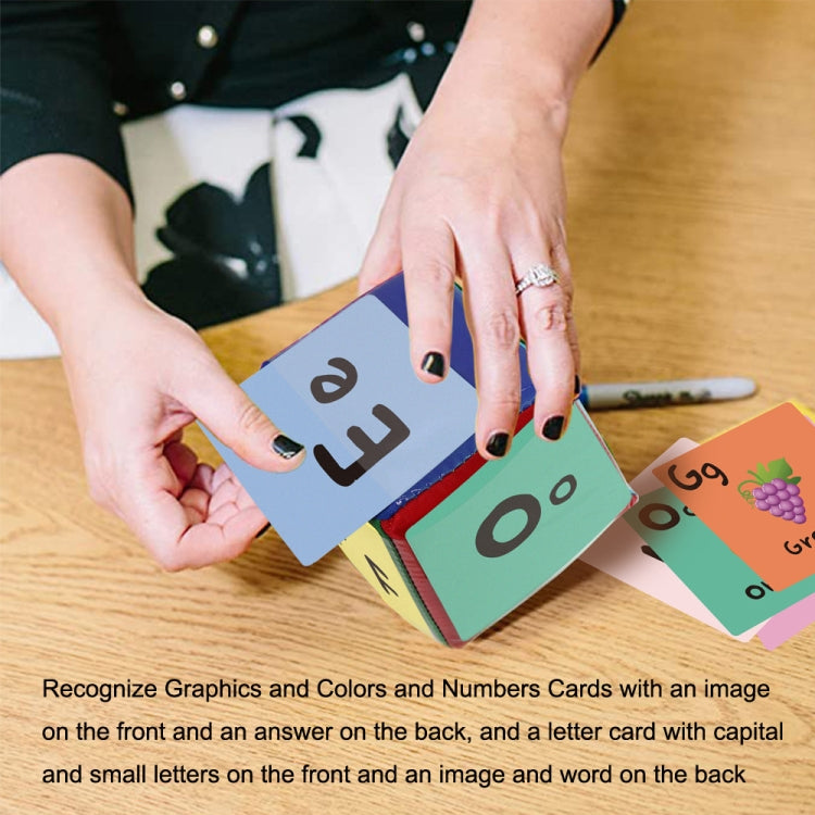 Hands playing with colorful letter and number cards from a learning dice set