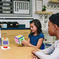 Children using a colorful learning dice cube with letter and picture cards