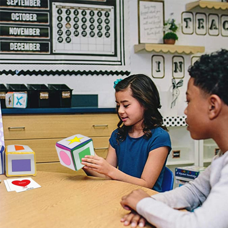 Children using a colorful learning dice cube with letter and picture cards