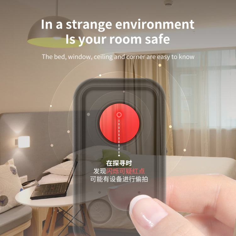 Black infrared detector with red sensor glow, held toward a surface with a finger.