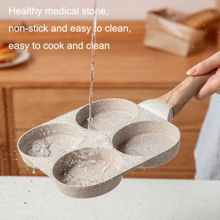 Four-hole nonstick egg pan with wooden handle; speckled gray stone cooking surface